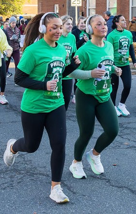 Runners wearing official Philly Shamrock Run shirts and race bibs at the 2026 Philadelphia 5K